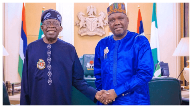 Daniel Bwala and President Bola Tinubu smiling and shaking hands inside Aso Villa, with Nigerian flags and official emblems in the background